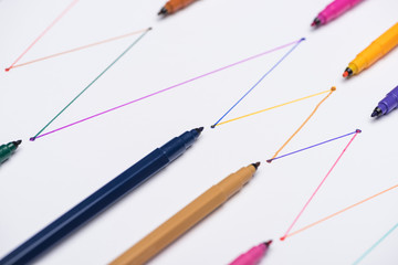 colorful felt-tip pens on white background with connected drawn lines, connection and communication...