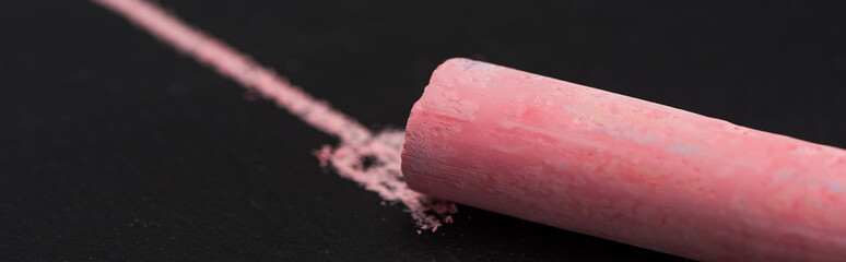 close up view of pink chalk on black surface with drawn line, connection concept