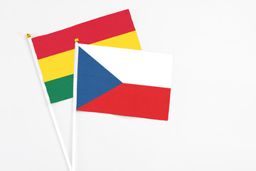 Czech Republic and Ghana stick flags on white background. High quality fabric, miniature national flag. Peaceful global concept.White floor for copy space.