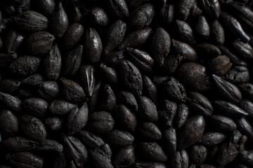 Black roasted malt for alcohol production. Roasted Barley background. Top view
