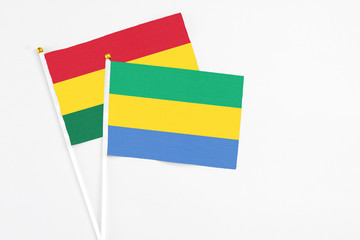 Gabon and Ghana stick flags on white background. High quality fabric, miniature national flag....