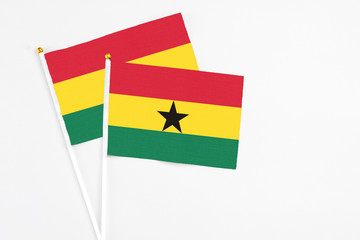 Ghana and Ghana stick flags on white background. High quality fabric, miniature national flag. Peaceful global concept.White floor for copy space.