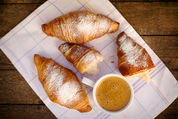 Freshly croissant and coffee for pleasure, delicious breakfast