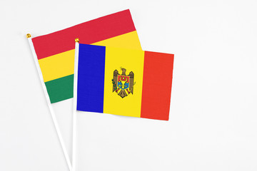 Moldova and Ghana stick flags on white background. High quality fabric, miniature national flag. Peaceful global concept.White floor for copy space.