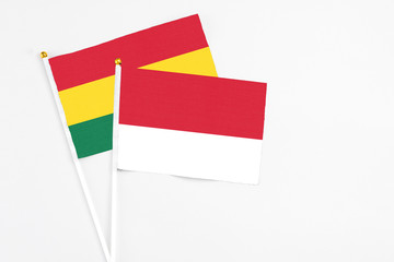 Monaco and Ghana stick flags on white background. High quality fabric, miniature national flag. Peaceful global concept.White floor for copy space.