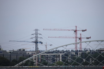 tower construction cranes on the background of houses