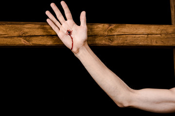 cropped view of jesus crucified on wooden cross isolated on black © LIGHTFIELD STUDIOS