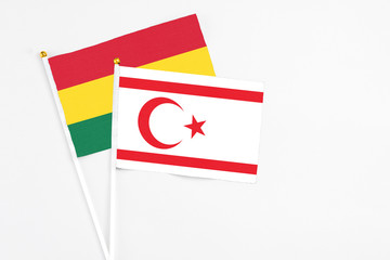 Northern Cyprus and Ghana stick flags on white background. High quality fabric, miniature national flag. Peaceful global concept.White floor for copy space.