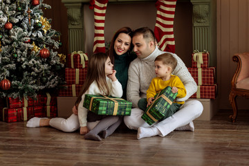 Obraz na płótnie Canvas Mom, dad and children on New Year`s holidays. Family concept