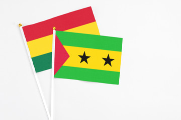 Sao Tome And Principe and Ghana stick flags on white background. High quality fabric, miniature national flag. Peaceful global concept.White floor for copy space.