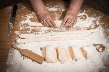 Fototapeta na wymiar Hands kneading dough for gnocchi.