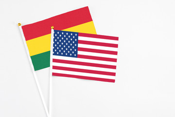 United States and Ghana stick flags on white background. High quality fabric, miniature national flag. Peaceful global concept.White floor for copy space.