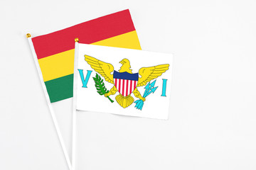 United States Virgin Islands and Ghana stick flags on white background. High quality fabric, miniature national flag. Peaceful global concept.White floor for copy space.