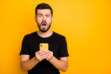 Portrait of impressed funky guy blogger use smartphone read unbelievable social media black friday...