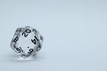 Isolated transparent 20 sided die for role playing or deck building games with a white background. Space for text available. Geek accessory also called d20.