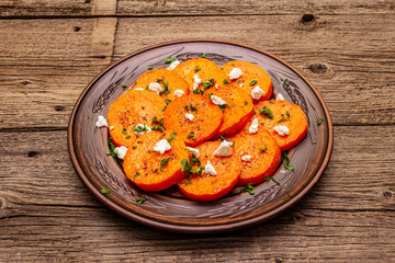 Roasted pumpkin with salted cheese and herbs