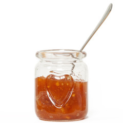 Glass jar with jam sauce, spoon and heart shape pattern white background