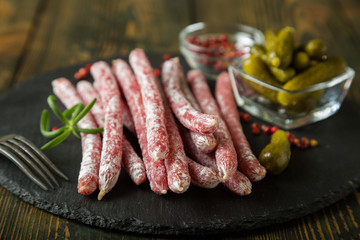 Smoked spanish sausage on the table. Meat appetizer