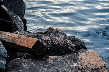 Texture of Sweden stone and wood near a water. Close up. Background. Texture.