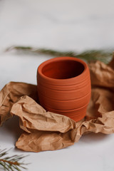ceramic mug clay red on a light marble background top view on Kraft paper