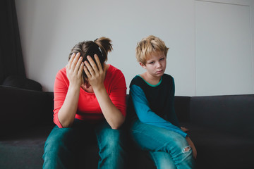 sad child with stressed mother, family in trouble