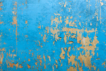 Old factory wall with blue peeling paint. Copy space.