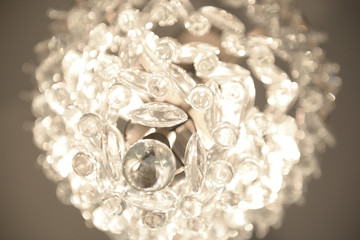 Up close of fancy crystal chandelier blurred home lighting