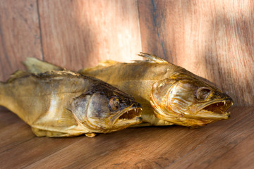 Smoked predatory fish. Zander. Cold smoked. Natural rustic background.