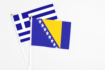 Bosnia Herzegovina and Greece stick flags on white background. High quality fabric, miniature...