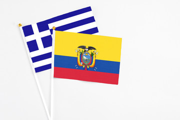 Ecuador and Greece stick flags on white background. High quality fabric, miniature national flag. Peaceful global concept.White floor for copy space.