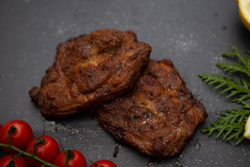  Sliced ​​ Piglet steak. Succulent meat of piglet on black marble background.