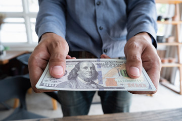 Man handed dollar bills to you, American money in hand, Cash in hands, Income and Business concept.