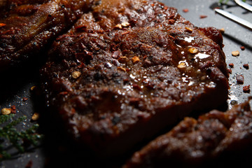  Sliced ​​ Piglet steak. Succulent meat of piglet on black marble background.