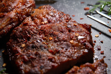  Sliced ​​ Piglet steak. Succulent meat of piglet on black marble background.