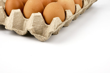 Close up Fresh organic natural brown Chicken eggs in paper tray isolated on white background.Healthy and Natural Food concept