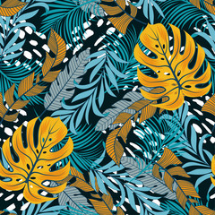 Fototapeta na wymiar Original seamless tropical pattern with bright yellow and white plants and leaves on a blue background. Seamless pattern with colorful leaves and plants. Exotic jungle wallpaper.
