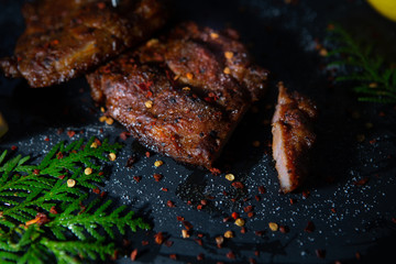  Sliced ​​ Piglet steak. Succulent meat of piglet on black marble background.