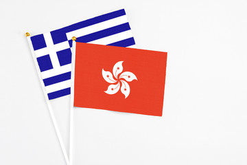 Hong Kong and Greece stick flags on white background. High quality fabric, miniature national flag. Peaceful global concept.White floor for copy space.