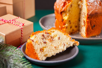 Traditional Christmas cake panettone with fruits and nuts with Christmas decoration