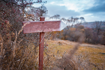 Signpost on hiking path in the mountain. Empty space