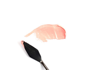 a painting palette knife isolated on a white background painting a pink with copy space.