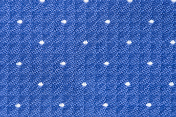 Solid background of blue fabric with a texture pattern. Close-up.