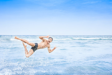 man jumping happily into the water