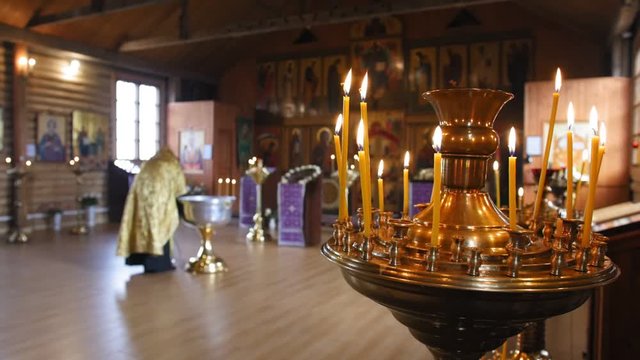 Burning candles. Secret rite of baptism in the orthodox church on the background. Close up shot.