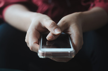 hipster woman using hands touching and typing on mobile phone screen search internet online working or social communication with digital 5G technology app device in coffee shop indoor lifestyle.