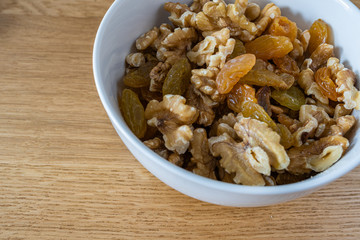 Mix of shelled walnuts and yellow raisins. The view from close delicacies.