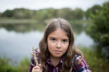 Girl with very serious look in outdoor setting.
