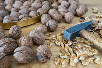 Walnuts on a natural oak wooden background. A natural perspective composition in brown and gold  colors.