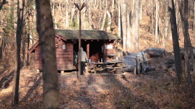Two backpackers pack up camp at the Maupin Field Shelter on the Appalachian Trail - Three Ridges Wilderness - George Washington National Forest, VA