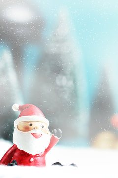 Christmas background with Santa claus, Lantern and christmas trees on table.